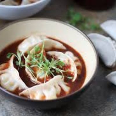 Chicken Cheese Momos Tossed In Sauce