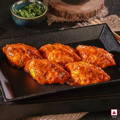 Chicken Masala Pan Fried Momo in Schezwan Sauce (Spicy)