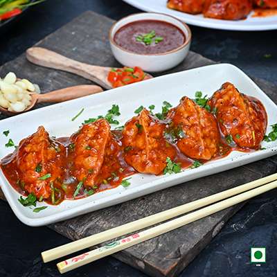 VEG PAHARI FEAST PAN FRIED MOMO IN TOMATO GARLIC SAUCE