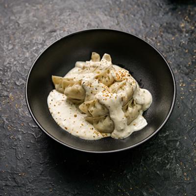 Corn Cheese Momo in Molten Cheesy Sauce