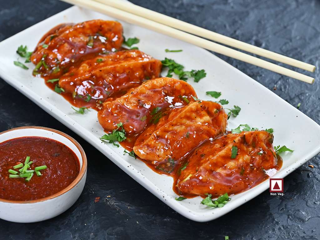 Chicken Pahari Feast Pan Fried Momo in Schezwan Sauce (Spicy)