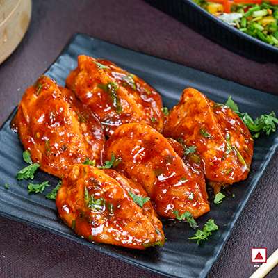 CHICKEN PAHARI FRESH PAN FRIED MOMO IN TOMATO GARLIC SAUCE
