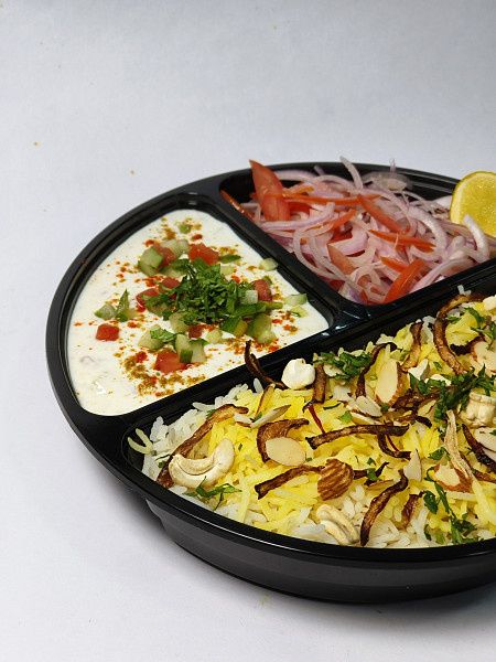 Awadhi Biriyani Served With Raita, Onion